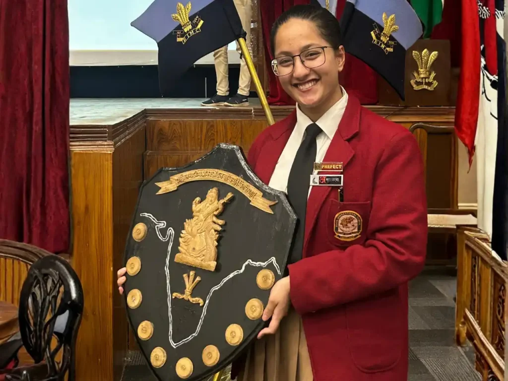 Devishi Uniyal celebrating a student competition achievement with a trophy