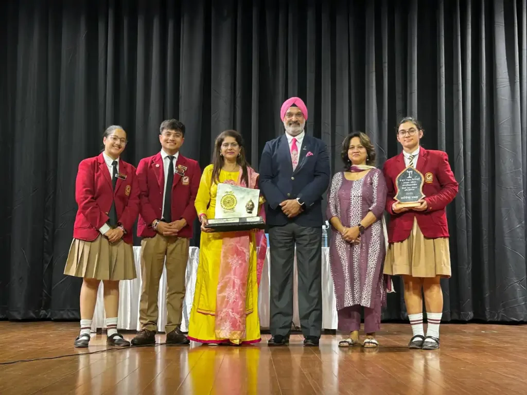 Devishi Uniyal celebrating a student competition achievement with a trophy